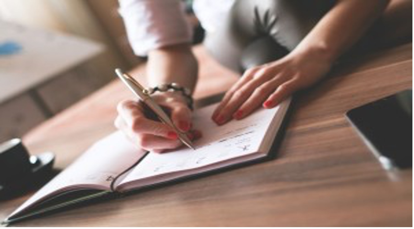 Person writing in notebook